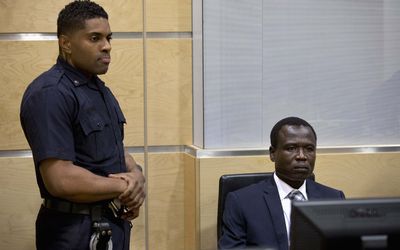 Dominic Ongwen, a commander of the Ugandan Lord's Resistance Army, waits for the start of court procedures as he makes his first appearance at the International Criminal Court in The Hague, Netherlands on Monday. Picture: REUTERS