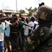 Angry men point at African Union soldiers at Gobongo district in Bangui on Thursday after residents had surrounded a convoy of Chadian Muslims fleeing the country. AU peacekeepers fired warning shots to disperse them. Picture: REUTERS
