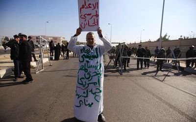 A supporter of Egypt's army rallies against Muslim Brotherhood members and ousted Egyptian President Mohamed Mursi outside a police academy on the outskirts of Cairo, Egypt, on Tuesday.  Picture: REUTERS