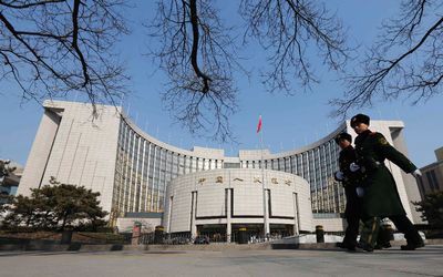 Paramilitary policemen patrol around the headquarters of China's central bank in Beijing.  Picture: REUTERS