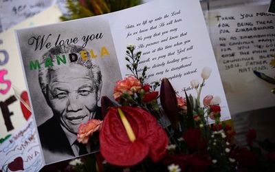 Cards and flowers are left outside the Medi-Clinic Heart Hospital, where the ailing former South African president Nelson Mandela is being treated, in Pretoria, on Friday.  Picture: REUTERS