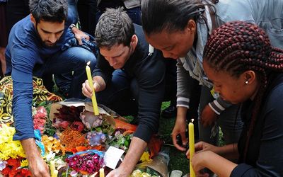 Mourners light candles in tribute to former president Nelson Mandela outside his home in Houghton, Johannesburg, on Friday.  Picture: GCIS