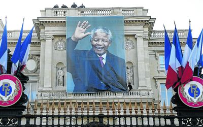 GLOBAL ICON: A banner of Nelson Mandela covers the facade of the foreign affairs ministry at Quai d’Orsay in Paris. Picture: REUTERS