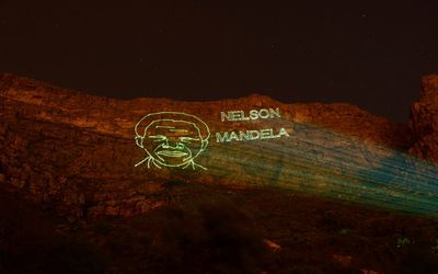 A nighttime laser display on Table Mountain in Cape Town pays tribute to late president Nelson Mandela. Picture: ERIC MILLER