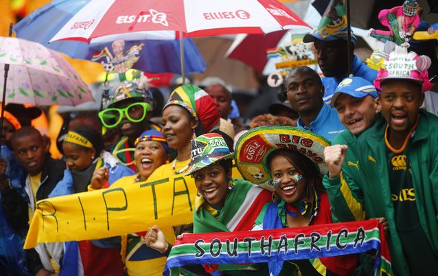People sing and dance while waiting for the start of the official memorial service for late president Nelson Mandela at the FNB Stadium in Johannesburg on Tuesday. Picture: REUTERS