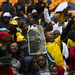 People sing and dance at the official memorial service for former president Nelson Mandela at FNB Stadium in Johannesburg on Tuesday. Picture: REUTERS