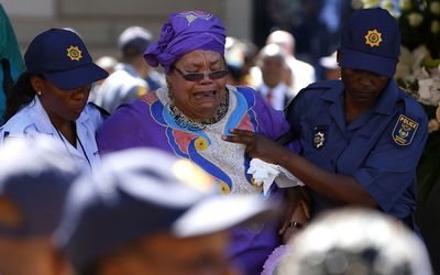 A woman cries after paying her respects at the coffin of former South African president Nelson Mandela at the Union Buildings in Pretoria on Thursday. Picture: REUTERS