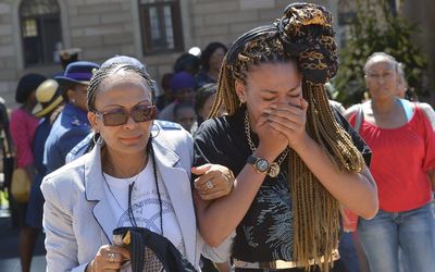 Women react after paying their respects to former South African president Nelson Mandela on the last day of Mandela's lying in state at the Union Buildings in Pretoria on Friday. Picture: REUTERS