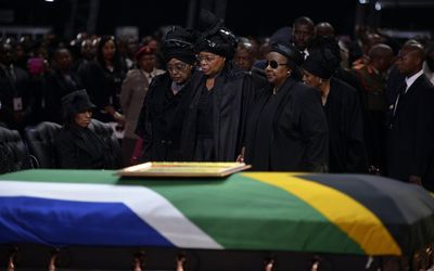 Nelson Mandela’s ex-wife Winnie Madikizela-Mandela (left) and widow Graca Machel (centre) during his funeral ceremony in Qunu on Sunday. Picture: REUTERS