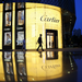 A pedestrian walks past a Cartier store, operated by Richemont, as it stands illuminated at night in Shanghai, China. Picture: BLOOMBERG 