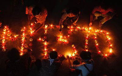 Residents of Boeung Kak Lake light candles to spell ‘MH370’ during a Buddhist prayer ceremony in Phnom Penh, Cambodia, on Monday. Picture: REUTERS