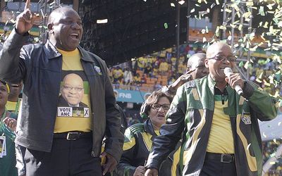 FRONTRUNNER: ANC deputy president Cyril Ramaphosa, left, sings at the party’s Siyanqoba rally at the weekend, alongside President Jacob Zuma. Picture: PUXLEY MAKGATHO