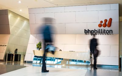 People walk through the foyer of the BHP Billiton headquarters in Melbourne, Australia. Picture: BLOOMBERG