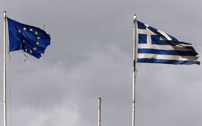 Frayed European Union and Greek flags flutter atop the Greek Ministry of Finance in central Athens.  Picture: REUTERS