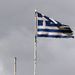 Frayed European Union and Greek flags flutter atop the Greek Ministry of Finance in central Athens.  Picture: REUTERS