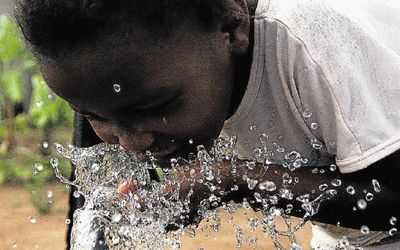 Qando Mkhize of Ntingewe in KwaZulu-Natal drinks clean water from a tap for the first time in her life after the area was affected by cholera for two years. Unhygienic conditions fuel major disease outbreaks such as cholera in developing countries. File picture: MASTER MOSUNKUTU
