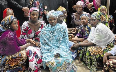 Chibok school girls who escaped from the Boko Haram Islamists gather to receive information from officials. Only 57 girls escaped hours after the attack a year ago, while 219 are still being held, despite efforts to find them. Picture: AFP