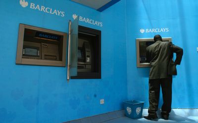 A man withdraws cash from a Barclays bank automatic teller machine outside Barclays Plaza in Nairobi. Picture: REUTERS/NOOR KHAMIS