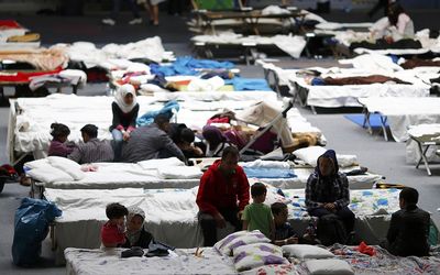 Migrants rest at a temporary shelter in a sports hall in Hanau, Germany, on Thursday. Picture: REUTERS/KAI PFAFFENBACH