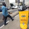A man passes an MTN board in Lagos, Nigeria.  Picture:  AFP PHOTO/PIUS UTOMI EKPEI