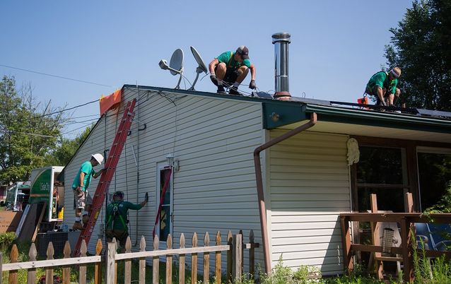SolarCity employees install solar panels on the roof of a home in Kendall Park, New Jersey, the US. Picture: BLOOMBERG/MICHAEL NAGLE