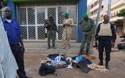 Malian soldiers display grenades and other supplies they said belonged to jihadists in front of the Radisson Blu hotel in Bamako, Mali. Picture: REUTERS/JOE PENNEY 