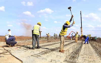 Construction workers work at an overpass bridge, a section of the Mombasa-Nairobi standard gauge railway, at Emali in Kenya last October. Picture: REUTERS/NOOR KHAMIS