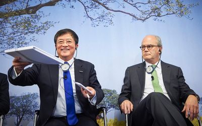Ren Jianxin, chairman of ChemChina hands over documents next to Michel Demare, chairman of Swiss farm chemicals giant Syngenta during a press conference to present Syngenta's annual results in Basel on Wednesday. Picture: AFP