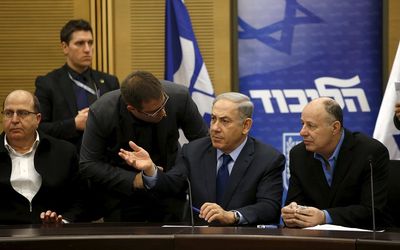 Israel's Prime Minister Benjamin Netanyahu chats with members of his party during a meeting of his Likud party in the Israeli parliament in Jerusalem on Monday. Picture: REUTERS