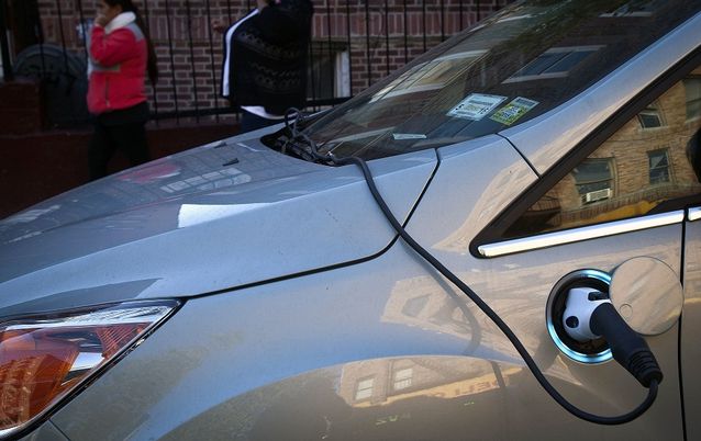 Expanding the use of electric cars, such as this one plugged in on a street in New York, requires buy-in from governments so that a policy framework to shape a new approach to mobility. Picture: REUTERS