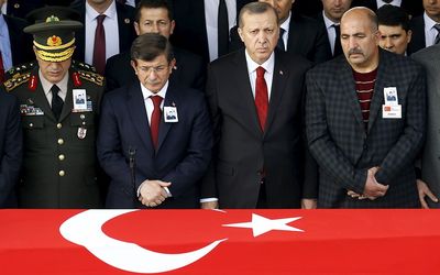 Turkish President Tayyip Erdogan (second right), Chief of Staff Gen Hulusi Akar, Prime Minister Ahmet Davutoglu (second left) stand behind the flag-draped coffin of a victim of Wednesday night's attack in Ankara, Turkey, on Thursday.  Picture: REUTERS/UMIT BEKTAS
