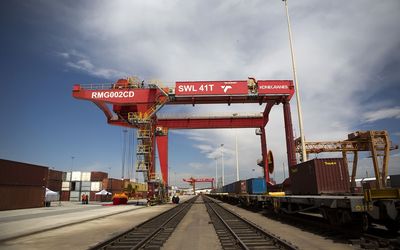 A loading crane straddles a freight rail track at Transnet’s container handling terminal at City Deep inland port in Johannesburg. Picture: BLOOMBERG