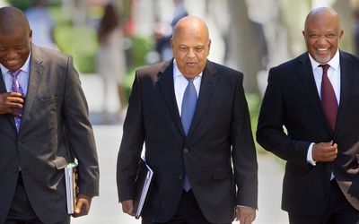 Finance Minister Pravin Gordhan (centre) arrives at Parliament to deliver his 2016 Budget Speech in Cape Town on Wednesda. Picture: AFP PHOTO/RODGER BOSCH
