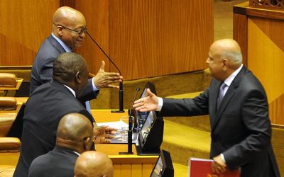President Jacob Zuma and Deputy President Cyril Ramaphosa shake hands with Finance Minister Pravin Gordhan after his budget speech in Cape Town on Wednesday. Picture: GCIS