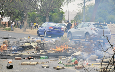 North West University students throw stones at police officers during a protest in October last year.  Picture: SOWETAN