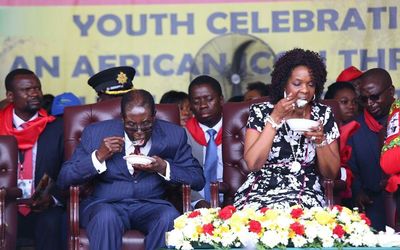 Zimbabwean President Robert Mugabe and his wife Grace as they take part in the party for Mr Mugabe's 92nd birthday held in Masvingo, Zimbabwe, on Saturday. Picture: EPA/AARON UFUMELI