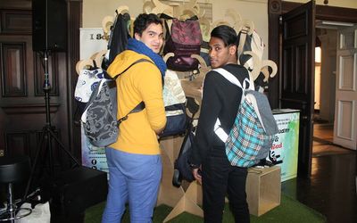 GREAT IDEAS: Cape Town-based Zaid Philander, left, shows off fashion bags that his company, I Scream & Red, makes from discarded vehicle seatbelts, fabric samples and upholstery. Picture: SUPPLIED
