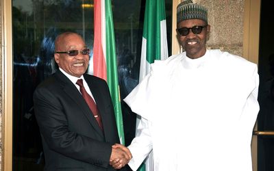 Nigerian President Muhammadu Buhari (right) greets South African counterpart Jacob Zuma at the presidential villa in Abuja, Nigeria, on Tuesday. Picture: AFP PHOTO/PHILIP OJISUA