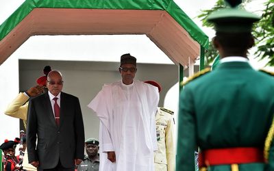 President Jacob Zuma, left, walks alongside Nigerian President Muhammadu Buhari during a visit to Nigeria on Tuesday.   Picture: GCIS