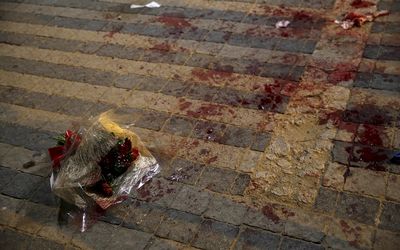 A bouquet stained with blood is seen where, according to Israeli police spokesperson, at least 10 Israelis were stabbed, in the popular Jaffa port area of Tel Aviv, Israel on Tuesday. Picture: REUTERS