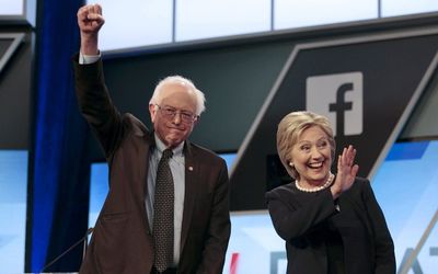 Democratic US presidential candidates Senator Bernie Sanders and Hillary Clinton wave before the start of the Univision News and Washington Post Democratic US presidential candidates debate in Kendall, Florida. Picture: REUTERS
