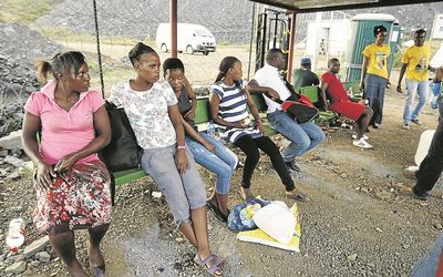 WAITING: People outside Lily Mine  in Barberton, Mpumalanga, wait for news about workers trapped underground. Picture: VATHISWA RUSELO/SOWETAN