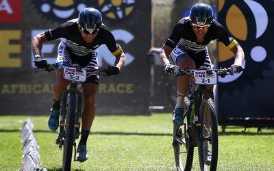 WINDING IT UP:  Urs Huber, left, and Karl Platt win the Absa Cape Epic prologue on Sunday. Picture: EPA/KIM LUDBROOK 