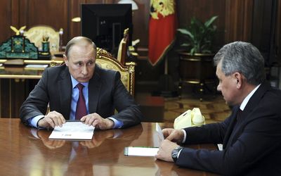 Russian President Vladimir Putin holds talks with Defence Minister Sergei Shoigu at the Kremlin in Moscow, Russia, on Monday. Picture: REUTERS/MIKHAIL KLIMENTYEV