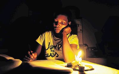 A Grade 12 learner uses a candle to study. The determination of very poor kids to uplift themselves inspires the writer, and organisations such as Five Plus provide the means through donor support. Picture: SOWETAN