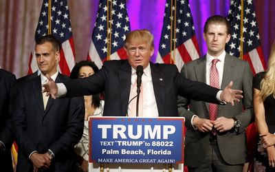 Republican US presidential candidate Donald Trump stands between his campaign manager Corey Lewandowski and his son Eric during a news conference held at his Mar-A-Lago Club in Palm Beach, Florida on Tuesday. Picture: REUTERS