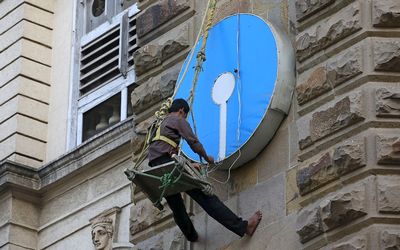 BALANCING ACT: An electrician puts lights on the logo of State Bank of India at its main branch in Mumbai, India. Although the country is now the world’s fastest-growing large economy, a huge amount of change is still needed. File picture: REUTERS/DANISH SIDDIQUI