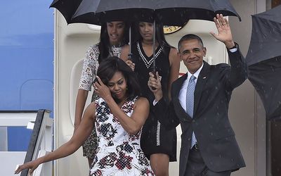 US President Barack Obama waves next to First Lady Michelle Obama (L) and their daughters Malia (L, behind) and Sasha upon their arrival at Jose Marti international airport in Havana on March 20, 2016. Picture: AFP/YURI CORTEZ