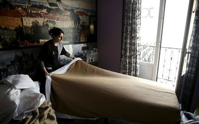 A chambermaid makes a bed inside a room at a hotel of the JC Rooms brand in Madrid, Spain. Picture: REUTERS/ANDREA COMAS