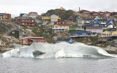 ON THE EDGE: The small town of Ilulissat in Greenland. Melting ice sheets mean coastal towns and cities may be underwater in the lifetimes of those born today. Picture: REUTERS